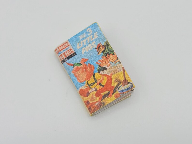 May include: A vintage paperback book titled "The 3 Little Pigs" from the "Classics Junior" series. The cover features an illustration of the three pigs and the wolf.