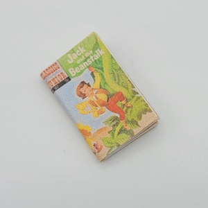 May include: A vintage paperback book titled "Jack and the Beanstalk" from the "Classics Junior" series. The cover features an illustration of Jack climbing a beanstalk with a giant in the background.