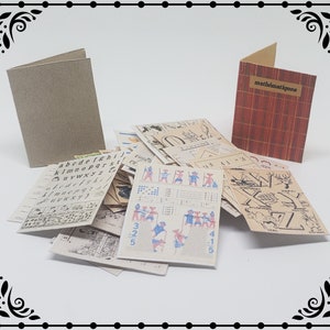 May include: A stack of vintage educational cards featuring a variety of subjects, including the alphabet, maths, and illustrations. The cards are in black and white with some red and blue accents. There are two closed cardboard covers, one with a brown texture and the other with a red and gold striped pattern. The red and gold cover has the word "mathematiques" printed on it.