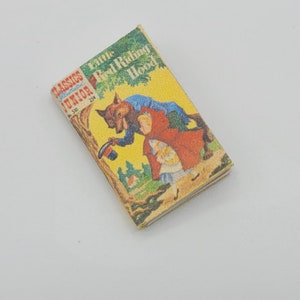 May include: A vintage Little Classics Junior book titled "Little Red Riding Hood" with a yellow cover and an illustration of a wolf and a girl in a red hood.
