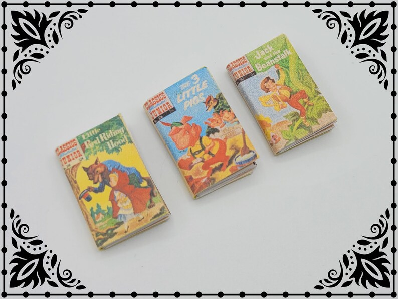 May include: Three miniature hardcover books with colorful illustrations. The titles are "Little Red Riding Hood", "The 3 Little Pigs", and "Jack and the Beanstalk".
