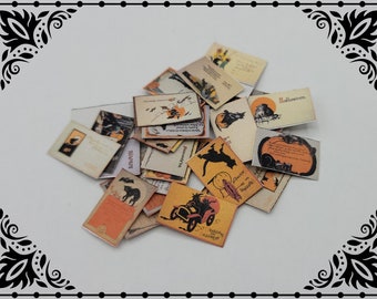 Puede incluir: Una colección de postales vintage de Halloween con gatos negros, calabazas y otras imágenes espeluznantes. Las postales están impresas en papel color crema con tinta negra y tienen un aspecto desgastado y antiguo.