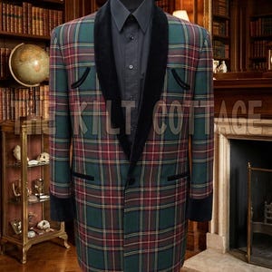 May include: A long, plaid jacket in green, red, and yellow, with black velvet lapels and cuffs, displayed on a mannequin. The jacket is paired with a black shirt. The text "THE KILT COTTAGE" is visible on the jacket.