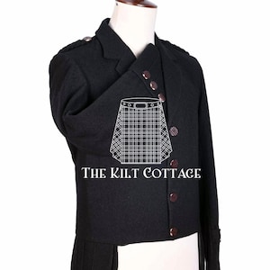 May include: A black wool kilt jacket with a double-breasted closure and a high collar. The jacket has a long tail and features a decorative button design. The text "THE KILT COTTAGE" is printed on the front of the jacket.