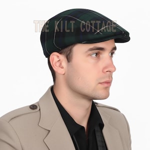 May include: A green and black plaid flat cap with a small brim. The cap has a classic design and is made of a woven fabric. The text "THE KILT COTTAGE" is printed on the top of the cap.