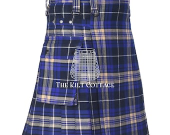 May include: A blue, beige, and white plaid kilt with a pleated design. The kilt features adjustable straps, metal hardware, and a pocket. The text "THE KILT COTTAGE" is visible on the front.