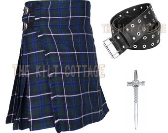 May include: A traditional kilt in a green, blue, and white plaid pattern, with a black leather belt and a decorative silver kilt pin. The kilt features a pleated design and buckle closures. The text "The Kilt Cottage" is visible.