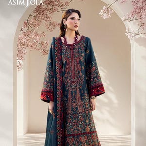 May include: A teal embroidered outfit, comprising a long-sleeved tunic and skirt, with intricate red and orange floral patterns. The sleeves and hem have a contrasting red border. The brand name "ASIM JOFA" is visible. The outfit is suitable for special occasions.