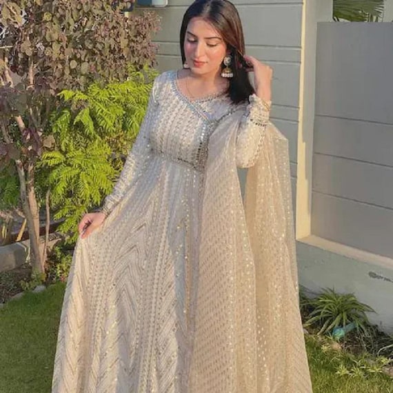 chiffon dress with dupatta Bamber chiffon embroidered shirt paired with a matching chiffon dupatta, featuring detailed threadwork across the fabric. The look is completed with a raw silk trouser, creating a balanced and
