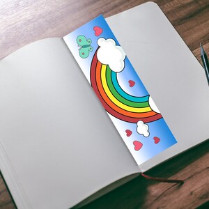 May include: A colorful rainbow bookmark with a butterfly, clouds, and hearts on a blue background.