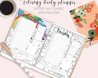 May include: A black and white printable daily planner featuring a colourful rainbow and flower design. The planner includes sections for scheduling, to-do lists, and mood tracking. The text "Monday" and "Tuesday" is visible on the planner.