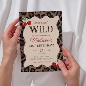 May include: A party invitation with a leopard print border and a cream-colored center. The text reads "Let's get WILD" and announces "Madison's 21st Birthday!" on July 25, 2026. Red cherries accent the design.