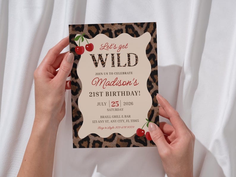 May include: A party invitation with a leopard print border and a cream-colored center. The text reads "Let's get WILD" and announces "Madison's 21st Birthday!" on July 25, 2026. Red cherries accent the design.