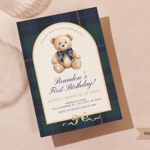 May include: A birthday invitation featuring a watercolor teddy bear with a blue bow. The invitation has a plaid border in navy and green. Text includes "Brandon's First Birthday!" and event details. The design is labeled "FRONT DESIGN".