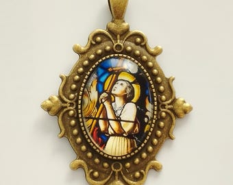 Gran colgante religioso de Santa Juana de Arco en la hoguera, hecho de metal y vidrio.