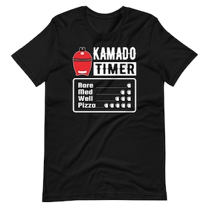 May include: Black t-shirt featuring a white graphic of a red kamado grill and the text "Kamado Timer". The graphic also includes a timer with the words "Rare", "Med", "Well", and "Pizza" and a series of white circles to represent time.