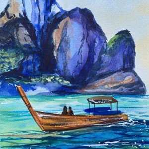 May include: Watercolour painting of a longtail boat on turquoise water, with two figures aboard. A large, blue and purple mountain rises in the background under a light blue sky. The boat is brown with a small canopy.