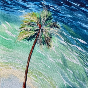 May include: A watercolour painting of a single palm tree on a beach with blue and green water in the background.