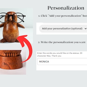 May include: A wooden penguin figurine wearing black glasses with the option to personalize the base with a name or short message. The base is engraved with the word "MONICA".
