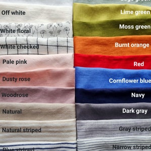 May include: A collection of folded linen fabric samples in various colors. Colors include milky white, off white, pale pink, dusty rose, sage green, lime green, burnt orange, red, cornflower blue, and navy. Some fabrics have floral, checked, or striped patterns.