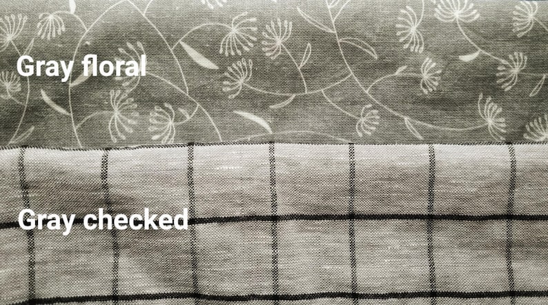 May include: Two gray fabric swatches. The top swatch features a floral pattern with white accents, labeled "Gray floral." The bottom swatch is a gray checked pattern, labeled "Gray checked."