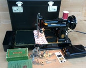 Singer 221K Featherweight Vintage Sewing Machine with accessories.