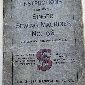 May include: Vintage Singer Sewing Machines No. 66 instruction manual from 1929. The cover is gray with black text and a red Singer logo. The manual provides instructions for using Singer sewing machines.
