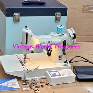 White Singer 221K Featherweight Sewing Machine with instruction manual