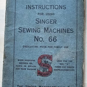 May include: A blue instruction manual for a Singer sewing machine model No. 66. The cover features the Singer logo with the text "Singer Sewing Machines" and "Oscillating Hook for Family Use". The manual was published in 1928.