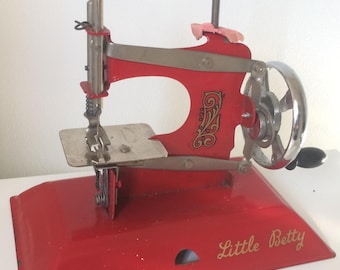 Red Vintage Little Betty Toy, Child's Hand Crank Chain Stitch