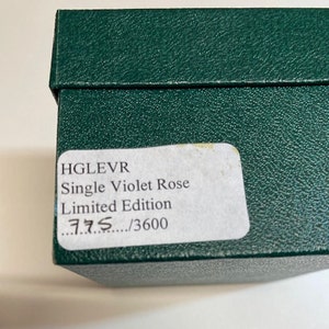 May include: A green box with a white label that reads "HGLVR Single Violet Rose Limited Edition 775/3600".