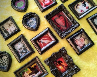 May include: A collection of small framed pictures with various designs and sayings. The frames are black and ornate. The pictures include a skull, a heart, a couple, and a cartoon character. The sayings include "Void & Chill", "Come to Butt Head", and "Your Monkey is on the Loose".