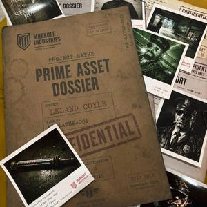 May include: A Murkoff Industries Project Lathe Prime Asset Dossier folder for Leland Coyle dated 04.02.1959, marked confidential. It includes various printed documents, photographs of a man in a police uniform, and a photo of an electrified stun rod.