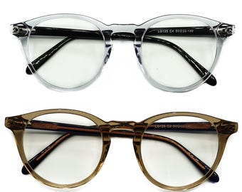 May include: Two pairs of round eyeglasses with clear lenses. The top pair has a clear frame and black arms. The bottom pair has a brown frame and dark blue arms. Both pairs have the text "LG125 C2 50D22-140" printed on the right arm.