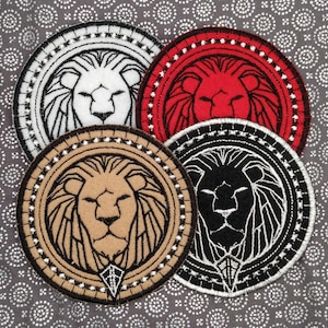 May include: Four embroidered lion head patches in different colors: white, tan, red, and black. Each patch is circular and features a lion head with a mane and a diamond shape at the bottom.