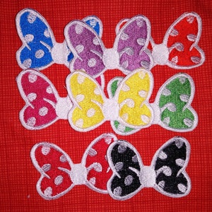 May include: Set of ten colorful fabric bow appliques with white polka dots. The bows are in various colors including red, blue, green, yellow, purple, and black.
