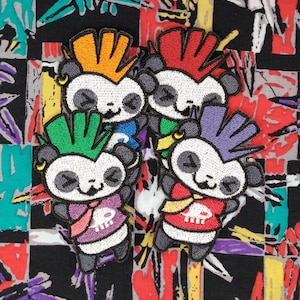 May include: Four embroidered iron-on patches featuring cartoon pandas with mohawks in different colors: orange, red, green, and purple. Each panda is wearing a different colored shirt with a skull and crossbones design.