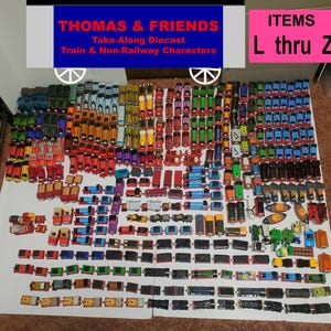 May include: A large collection of Thomas & Friends Take-Along diecast trains and non-railway characters arranged in rows. The image includes a blue header with the text THOMAS & FRIENDS Take-Along Diecast Train & Non-Railway Characters and a pink box with the text ITEMS L thru Z.