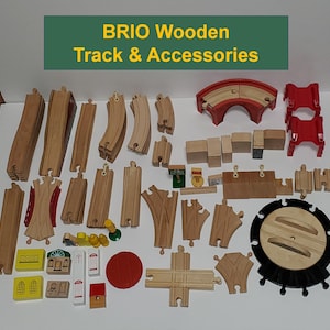 May include: A collection of wooden train track pieces and accessories from the brand BRIO. The set includes straight track, curved track, switches, a bridge, a tunnel, and other accessories. The pieces are made of natural wood and are in good condition.