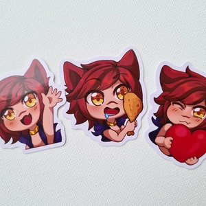 May include: Three cartoon stickers featuring a red-haired cat-like character with yellow eyes. The first sticker shows the character waving. The second sticker shows the character eating a fried chicken leg. The third sticker shows the character holding a red heart.