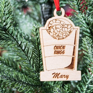 May include: Wooden Christmas ornament shaped like an onion ring container with the text "Onion Rings" and the name "Mary".