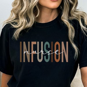 May include: Black t-shirt with the text "INFUSION nurse" in colorful letters. The letters are stacked vertically and have a gradient effect.