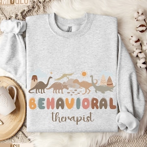 Sudadera de terapeuta de conducta de dinosaurios, suéter de analista de conducta de dinosaurios, especialista en conducta, terapia, técnico en conducta registrado, BCBA, ABA