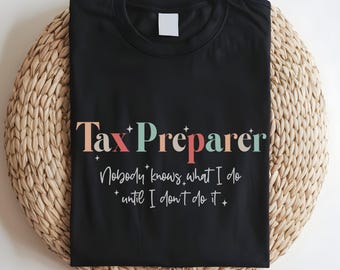 May include: Black t-shirt with the text "Tax Preparer" in colorful letters and the phrase "Nobody knows what I do until I don't do it" in white text.
