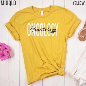 May include: Yellow t-shirt with the text "ONCOLOGY" in white and "Hematology" in black script.