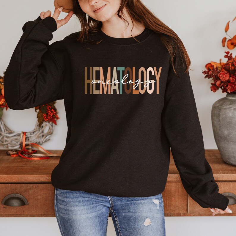 May include: Black sweatshirt with the text "HEMATOLOGY oncology" in colorful letters.