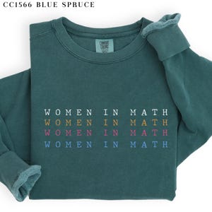 May include: A teal blue sweatshirt with the text "WOMEN IN MATH" repeated four times in different colors.
