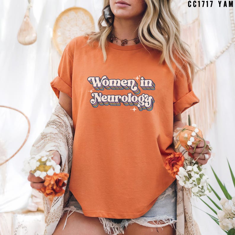 May include: Orange t-shirt with the text "Women in Neurology" in a retro rainbow font.