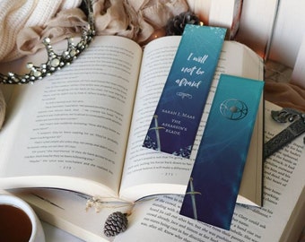 May include: Two blue and purple bookmarks with a fantasy theme. The bookmarks feature a sword and the text "I will not be afraid" and "The Assassin's Blade".