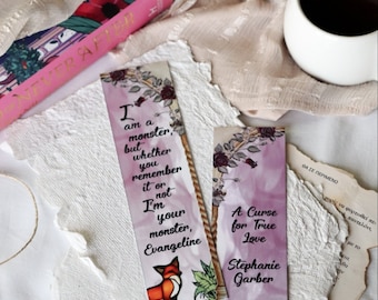 May include: Two pink and purple bookmarks with quotes from the book "A Curse for True Love" by Stephanie Garber. The first bookmark features a fox and the quote "I am a monster, but whether you remember it or not I'm your monster, Evangeline". The second bookmark features an apple and an arrow and the quote "A Curse for True Love".